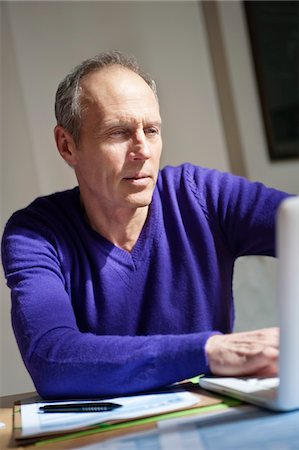 Man working on a laptop Stock Photo - Premium Royalty-Free, Code: 6108-05867359
