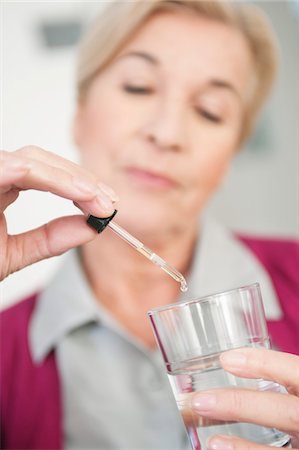 Close-up of a woman taking medicine Stock Photo - Premium Royalty-Free, Code: 6108-05867308