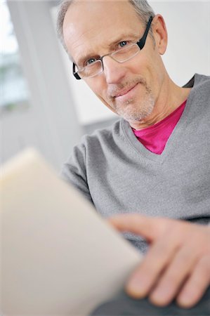 Portrait of a man holding a book Stock Photo - Premium Royalty-Free, Code: 6108-05867466
