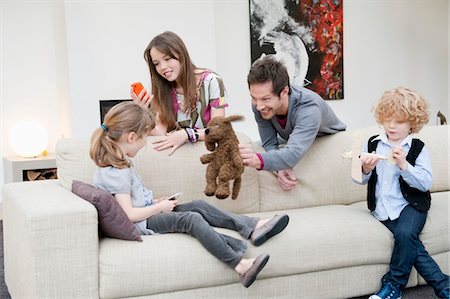 sister with toys - Family in a living room Stock Photo - Premium Royalty-Free, Code: 6108-05867490