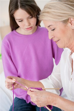 Woman teaching her granddaughter to knit Stock Photo - Premium Royalty-Free, Code: 6108-05867576