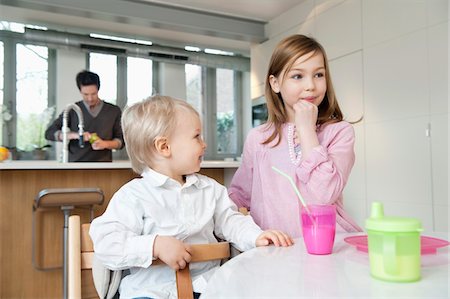 simsearch:6108-06167425,k - Girl at a breakfast table with her brother Stock Photo - Premium Royalty-Free, Code: 6108-05867504