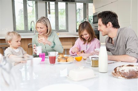 people eating on dining table - Family at a breakfast table Stock Photo - Premium Royalty-Free, Code: 6108-05867645