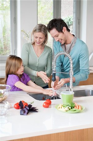 parent cooking girl father - Family preparing food in the kitchen Stock Photo - Premium Royalty-Free, Code: 6108-05867619