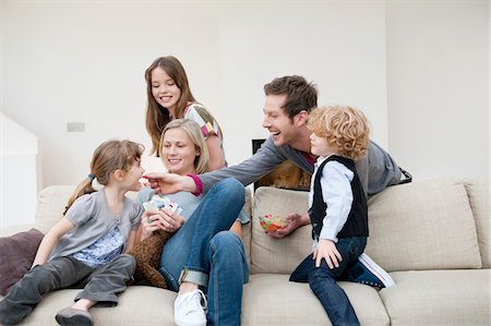 Family in a living room Stock Photo - Premium Royalty-Free, Code: 6108-05867712