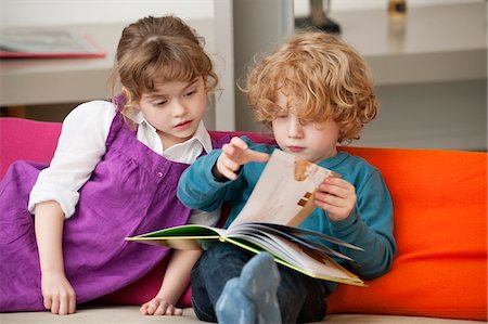 simsearch:632-08227559,k - Boy sitting with his sister and reading a book Stock Photo - Premium Royalty-Free, Code: 6108-05867729
