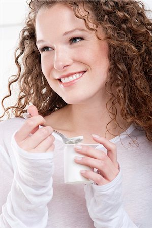 Close-up of a woman eating yogurt Stock Photo - Premium Royalty-Free, Code: 6108-05867850