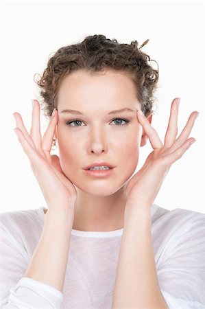 Portrait of a woman rubbing temples Stock Photo - Premium Royalty-Free, Code: 6108-05867859