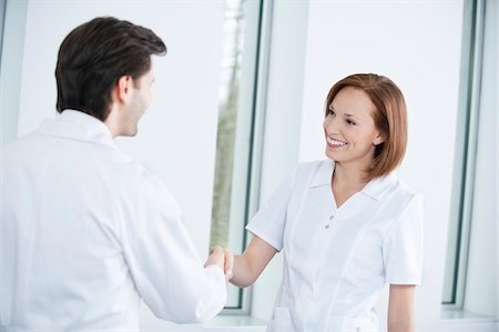 Two doctors shaking hands Stock Photo - Premium Royalty-Free, Code: 6108-05867964