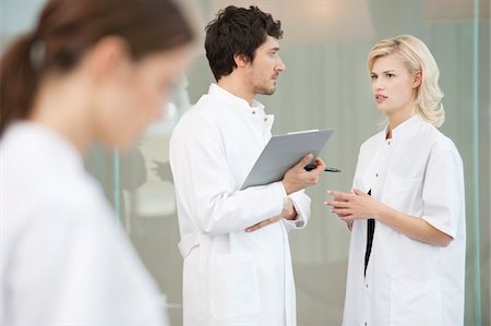 Two doctors discussing each other Stock Photo - Premium Royalty-Free, Code: 6108-05867906