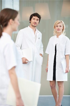 Male doctor standing with two female doctors Stock Photo - Premium Royalty-Free, Code: 6108-05867928
