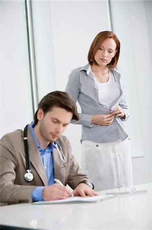 Woman getting dressed after treatment Stock Photo - Premium Royalty-Free, Code: 6108-05868044