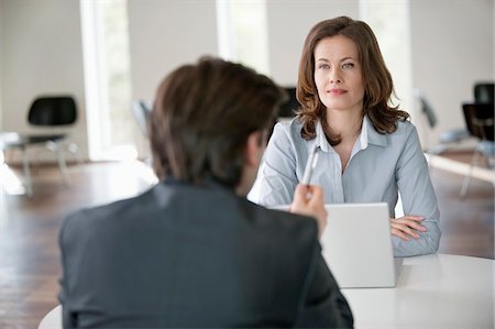Businesswoman discussing with an advisor Stock Photo - Premium Royalty-Free, Code: 6108-05868059