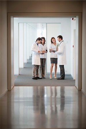 female doctors and male medical exam photos - Four doctors examining medical reports Stock Photo - Premium Royalty-Free, Code: 6108-05868024