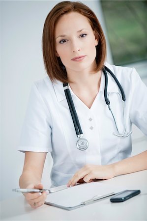 Female doctor working in an office Stock Photo - Premium Royalty-Free, Code: 6108-05868158