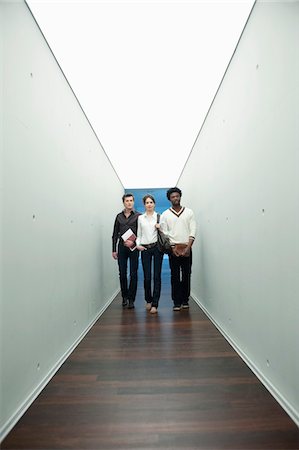 simsearch:6108-05868267,k - Business executives walking in the corridor of an office Stock Photo - Premium Royalty-Free, Code: 6108-05868296