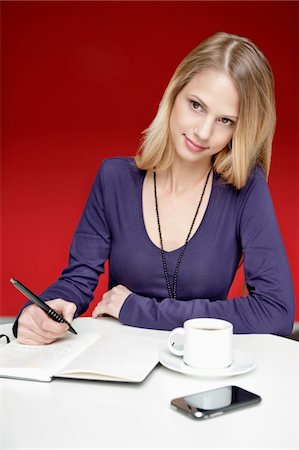 Businesswoman working in an office Stock Photo - Premium Royalty-Free, Code: 6108-05868394