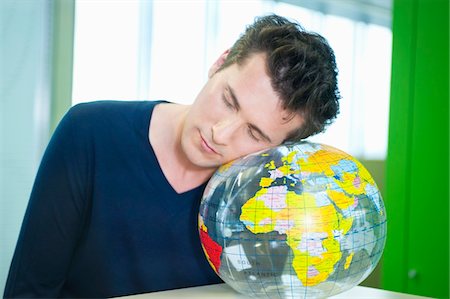 Homme d'affaires, faire la sieste sur un globe dans un bureau Photographie de stock - Premium Libres de Droits, Code: 6108-05868480