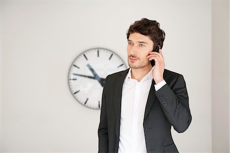 Businessman talking on a mobile phone Stock Photo - Premium Royalty-Free, Code: 6108-05868400