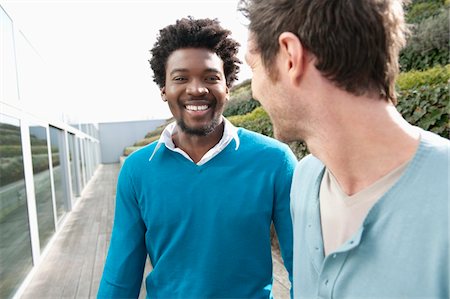 Friends discussing on a boardwalk Stock Photo - Premium Royalty-Free, Code: 6108-05868511