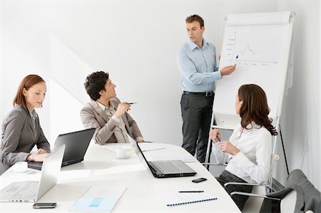 female business presentation pointing - Businessman giving presentation in a meeting Stock Photo - Premium Royalty-Free, Code: 6108-05868538