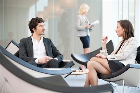 sitting crossed legs man - Business executives discussing in a waiting room Stock Photo - Premium Royalty-Free, Code: 6108-05868767