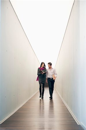 Business executives walking in the corridor of an office Stock Photo - Premium Royalty-Free, Code: 6108-05868780