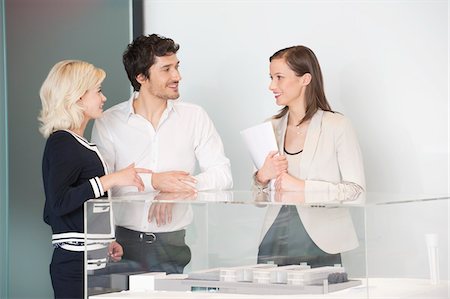 Man with two women near an architectural model Stock Photo - Premium Royalty-Free, Code: 6108-05868844