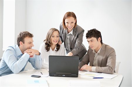 simsearch:6108-05868312,k - Business executives looking at a laptop in a board room Stock Photo - Premium Royalty-Free, Code: 6108-05868848