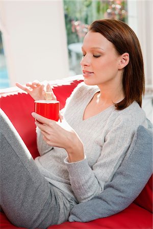 sip of tea - Young woman drinking coffee Stock Photo - Premium Royalty-Free, Code: 6108-05868963