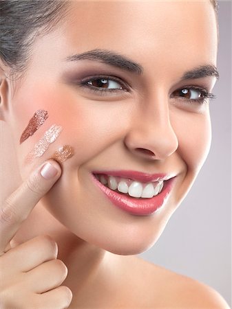 foundation makeup - Young woman applying foundation Stock Photo - Premium Royalty-Free, Code: 6108-05869073