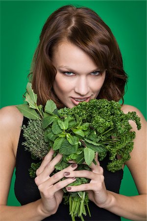 simsearch:6108-05869336,k - Young woman holding fresh herbs Stock Photo - Premium Royalty-Free, Code: 6108-05869130