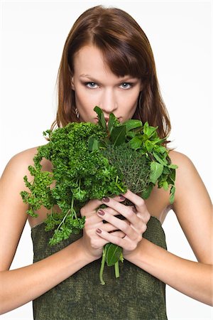 foul odor - Young woman holding fresh herbs Stock Photo - Premium Royalty-Free, Code: 6108-05869138