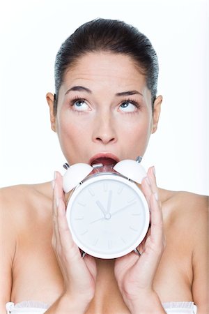 person alarm - Young woman holding alarm clock Stock Photo - Premium Royalty-Free, Code: 6108-05869398