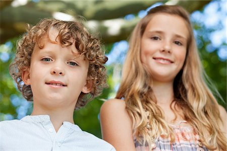 Close-up of smiling brother and his sister Stock Photo - Premium Royalty-Free, Code: 6108-05869468