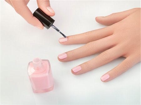 simsearch:6108-05869460,k - Woman painting fingernails, close-up Stock Photo - Premium Royalty-Free, Code: 6108-05869421