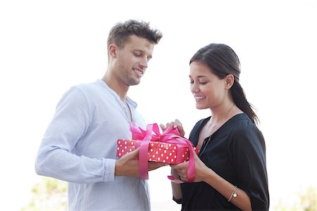 Man giving a present to his girlfriend Stock Photo - Premium Royalty-Free, Code: 6108-05869529