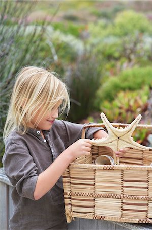 Close-up of a girl holding a starfish toy Stock Photo - Premium Royalty-Free, Code: 6108-05869722