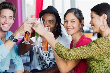 Portrait of friends toasting drinks in a restaurant Stock Photo - Premium Royalty-Free, Code: 6108-05869817