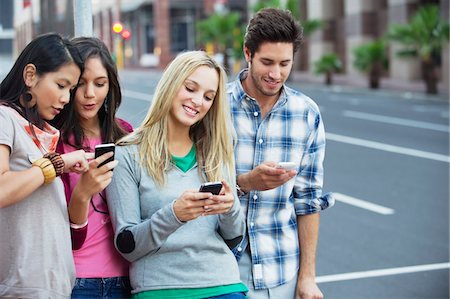 friends lifestyle city - Friends using mobile phones outdoors Stock Photo - Premium Royalty-Free, Code: 6108-05869814