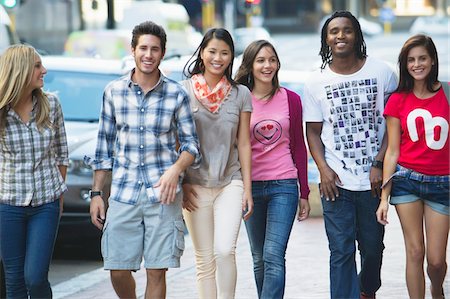 simsearch:6108-05874973,k - Friends walking on the sidewalk against cars Stock Photo - Premium Royalty-Free, Code: 6108-05869822