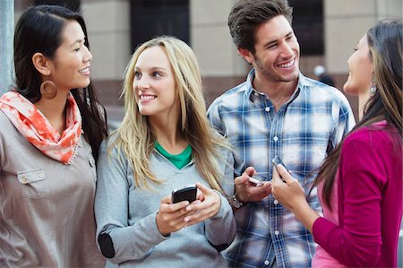 discussion group photo - Friends using mobile phones outdoors Stock Photo - Premium Royalty-Free, Code: 6108-05869824