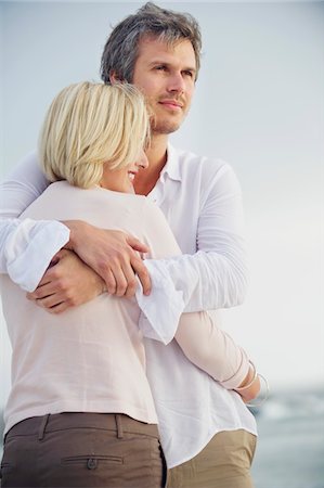 simsearch:6108-05869979,k - Mid adult man embracing his wife Stock Photo - Premium Royalty-Free, Code: 6108-05869941