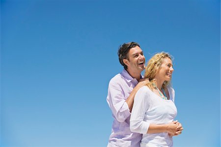 Side profile of a couple smiling Stock Photo - Premium Royalty-Free, Code: 6108-05869954