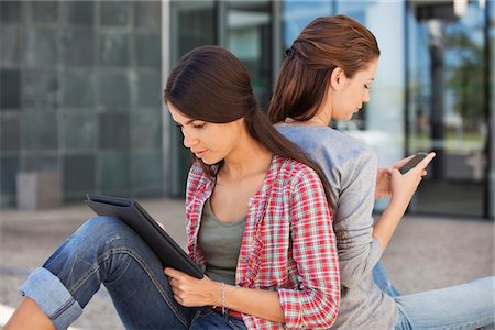 sent - Female friends holding file and mobile phone Stock Photo - Premium Royalty-Free, Code: 6108-05870114