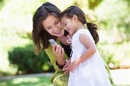 Woman and her granddaughter reading a text message Stock Photo - Premium Royalty-Free, Code: 6108-05870133