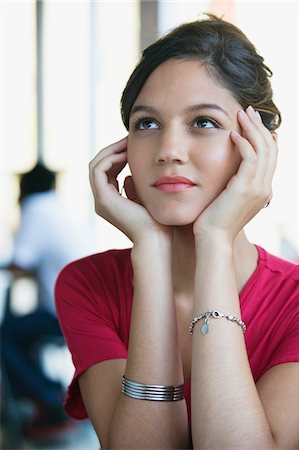 Contemplative woman looking up with head in hands Stock Photo - Premium Royalty-Free, Code: 6108-05870262