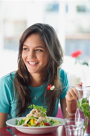 eating restaurant not eye contact - Beautiful woman eating food in a restaurant Stock Photo - Premium Royalty-Free, Code: 6108-05870282