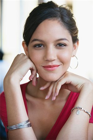 Portrait of a woman with hand on chin Stock Photo - Premium Royalty-Free, Code: 6108-05870287