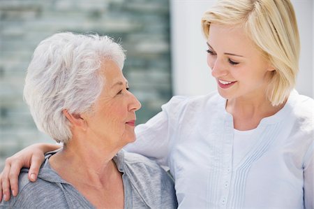 senior women blond short hair - Senior woman and her daughter looking at each other and smiling Stock Photo - Premium Royalty-Free, Code: 6108-05870379